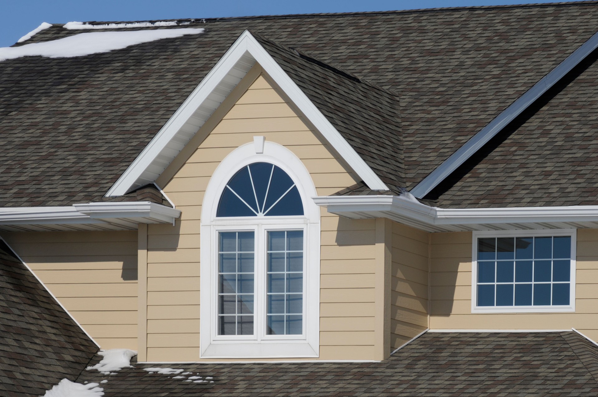 Nice House with Gabled Asphalt Shingle Roof and Snow